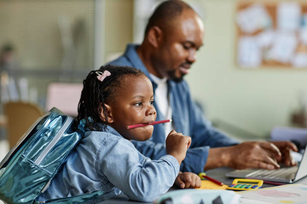istock Cute black child playing with pencils 1449533448