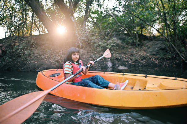 istock Girl kayaking in the river at sunset 1449535404