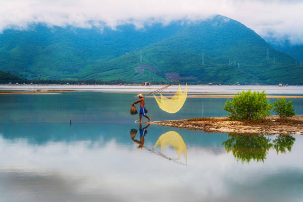 istock Fisherman in Lap An lagoon 1449542395