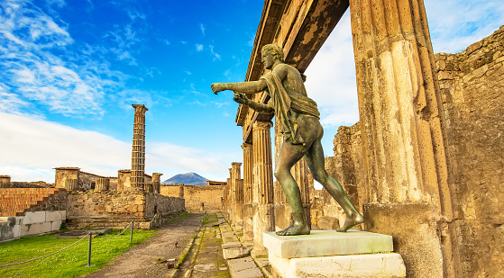 Ancient Pompeii city skyline and bronze Apollo statue, Italy travel photo