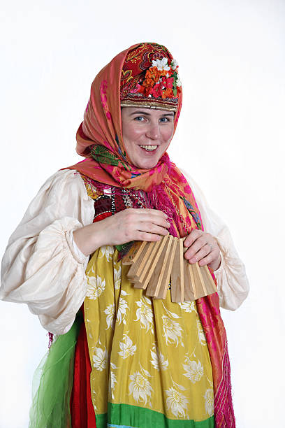 Womain in Russian clothes playing instrument stock photo
