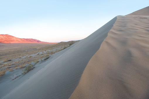Singing dune attraction at sunset in Altyn Emel National Park in Kazakhstan