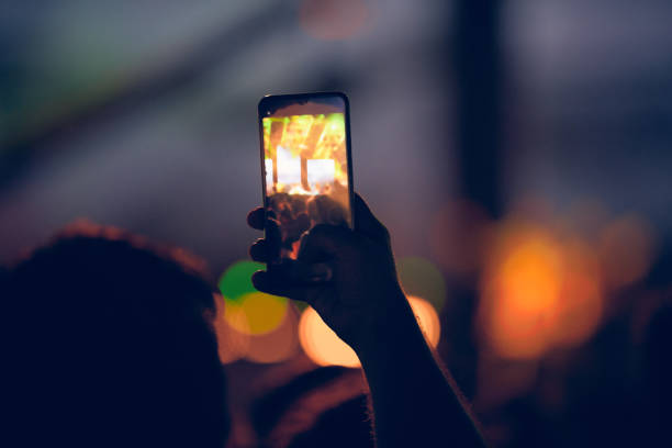 istock Person holding modern smartphone on a concert. 1449548958