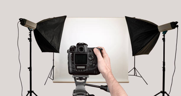 istock Male hand shoot with black camera in photo studio. 1449550075