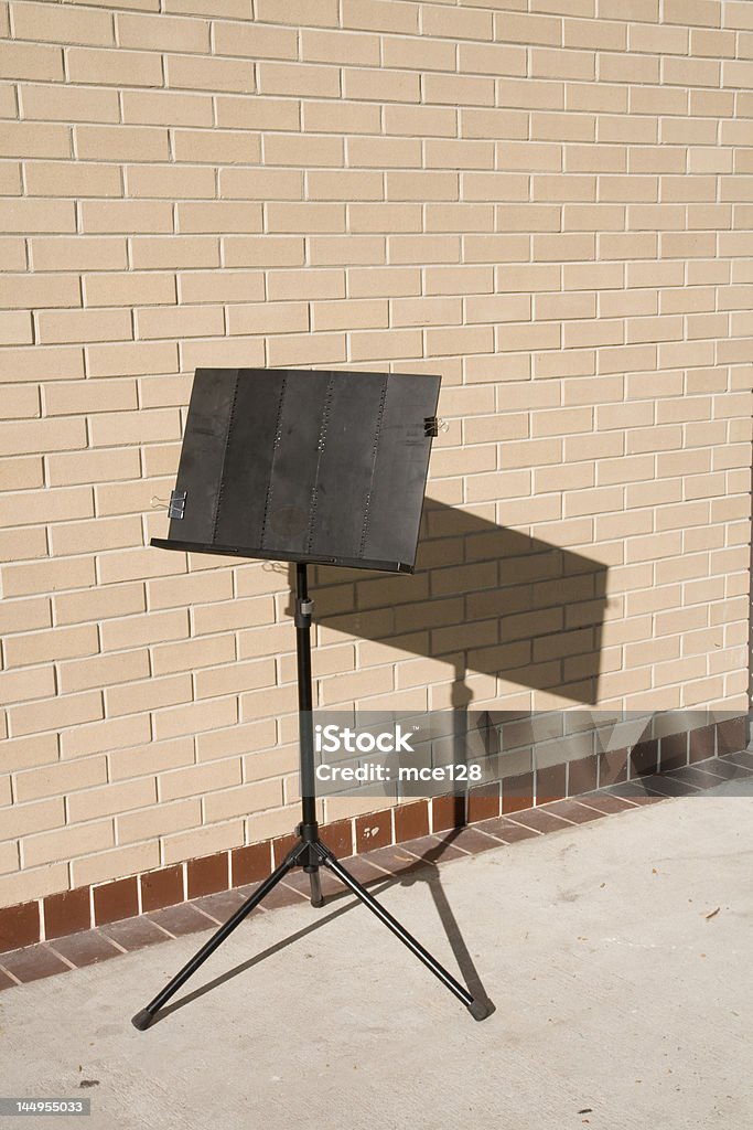 Music Easel Folding music easel near brick wall in the afternoon Music Stand Stock Photo