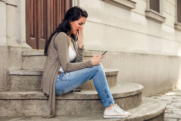 istock Young cute female using smartphone on the street. 1449550458