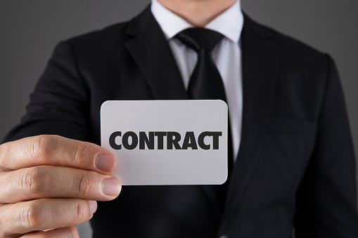 Businessman is holding Contract message card