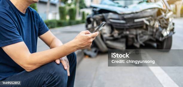 Man Calling With Phone To His Insurance Agent After Traffic Accident With A Background Of The Crashed Car Car Insurance An Nonlife Insurance Concept Stock Photo - Download Image Now