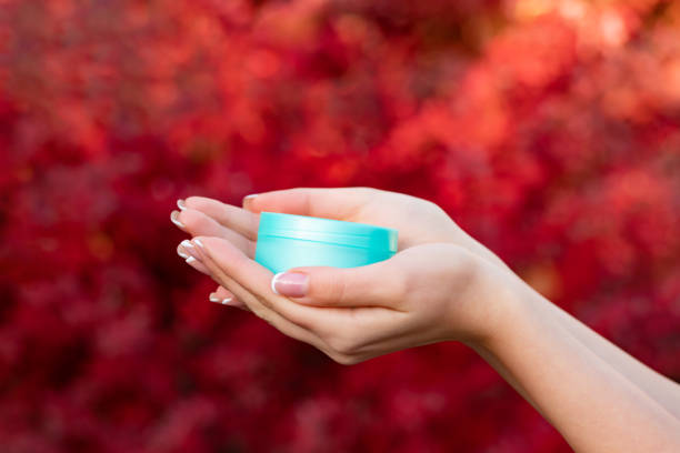 istock hands holding cream jar for skincare. hand cream 1449554692