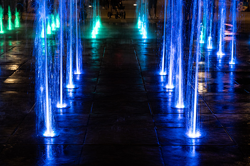 City fountain with blue neon lights.