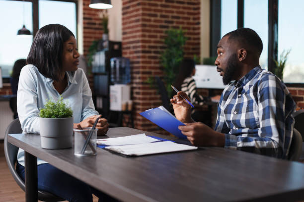 istock Executive manager having candidate CV resume while discussing about job description and salary offer. 1449557993