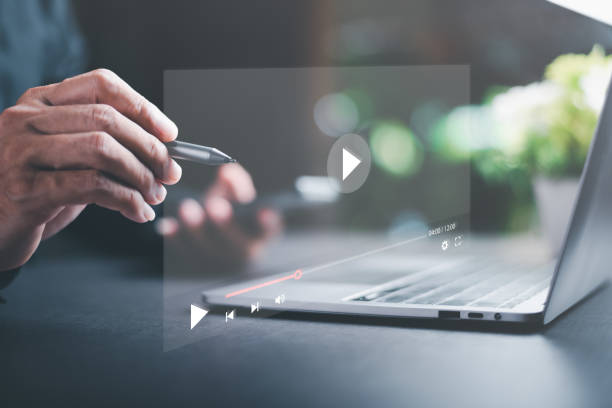 istock young man using laptop to watch video,Training, learning, teaching, virtual reality used in online video conferencing,Online streaming Watch videos on the Internet 1449559111