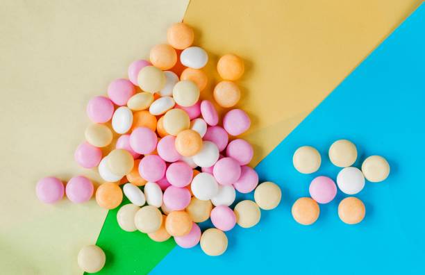 Overhead shot of sweet candies on the colorful surface An overhead shot of sweet candies on the colorful surface Mentos stock pictures, royalty-free photos & images