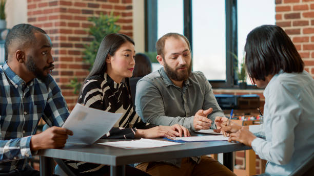 istock Displeased worker getting fired by multiethnic group of people 1449560481