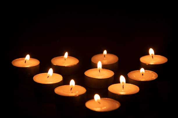 Light candles arranged in a triangle shape Light candles arranged in a triangle shape in the dark selective focus flaming o symbol stock pictures, royalty-free photos & images