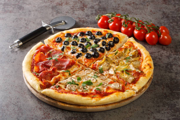 Homemade pizza four seasons with tomatoes, mozzarella, mushrooms, artichokes, ham and olives close-up. Horizontal stock photo