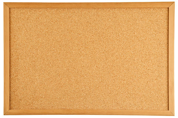 A brown cork bulletin board with a wooden frame
