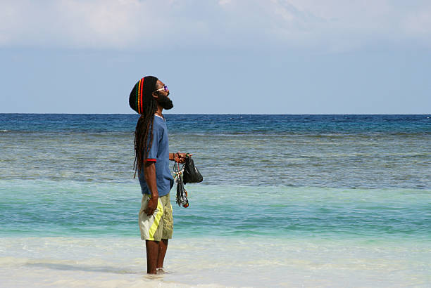 Jamaican man overlooking the sea stock photo