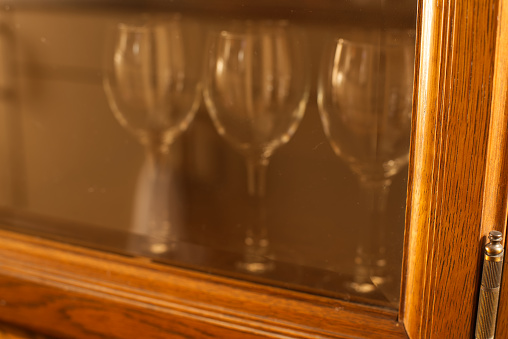 Wine glasses in cupboard.