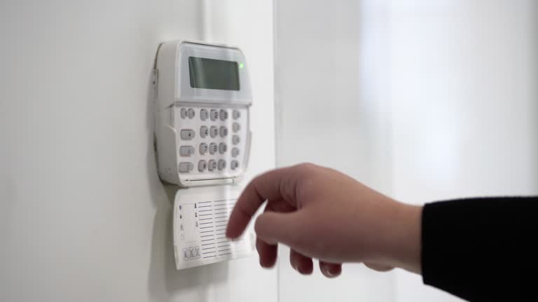 Hand entering alarm system password of an apartment, home or business office. Surveillance and protection console against rubbery and thief