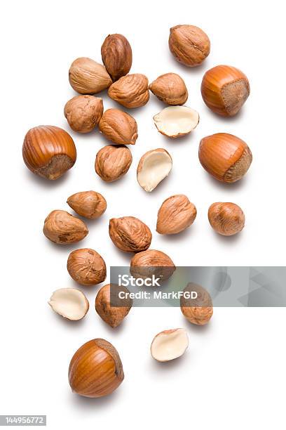 Several Hazelnuts Lying On A White Surface Stock Photo - Download Image Now - Hazelnut, White Background, Cut Out