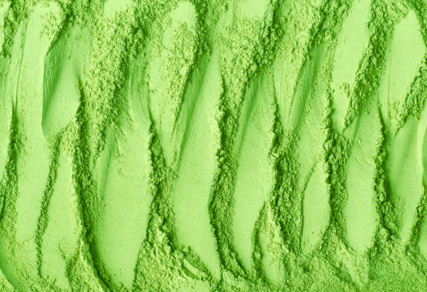 istock Green tea matcha powder texture close up, selective focus. Abstract background with brush strokes. 1449571632