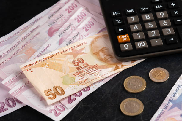 Turkish Liras and calculator on black background. stock photo