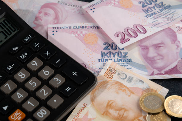 istock Turkish Liras and calculator on black background. 1449572946