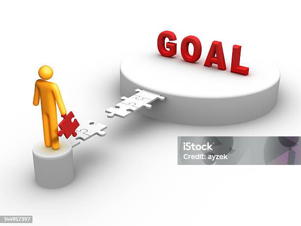 A Yellow Cartoon Mans Holding A Piece To Reach The Word Goal Stock Photo - Download Image Now