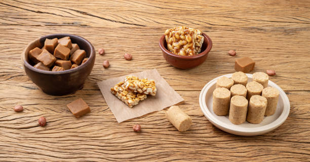 istock Typical brazilian candies over wooden table. Doce de leite or dulce de leche, pe de moleque and pacoca 1449574379