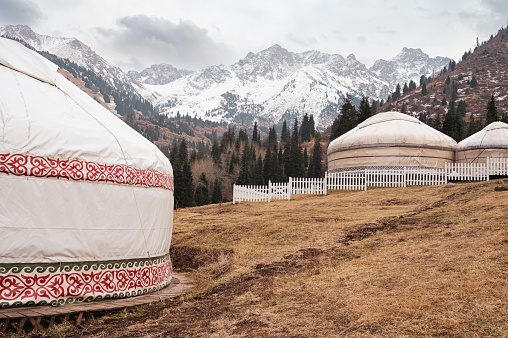 Traditional yurt in the mountains of Kazakhstan against the background of snowy mountains