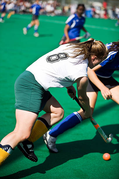 istock Girl playing field hockey 144957659