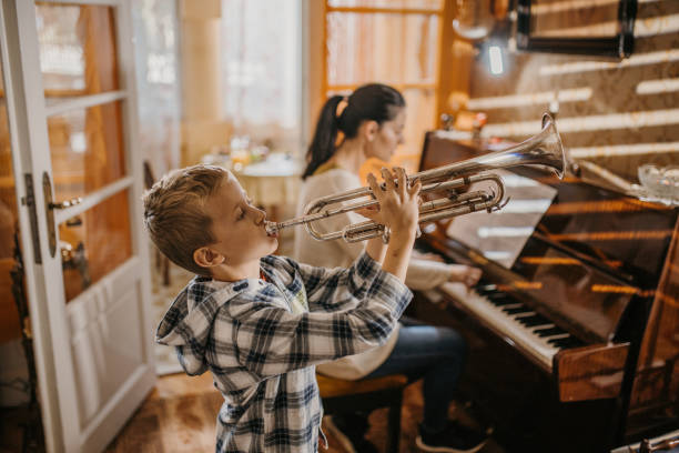 istock Young boy playing a trumpet 1449579580