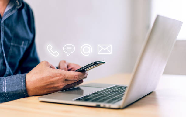 istock Hotline service, Customer support hotline Contact us people connection. Businessman using Smart Phone with the email, call phone, address, Chat message icons 1449580230