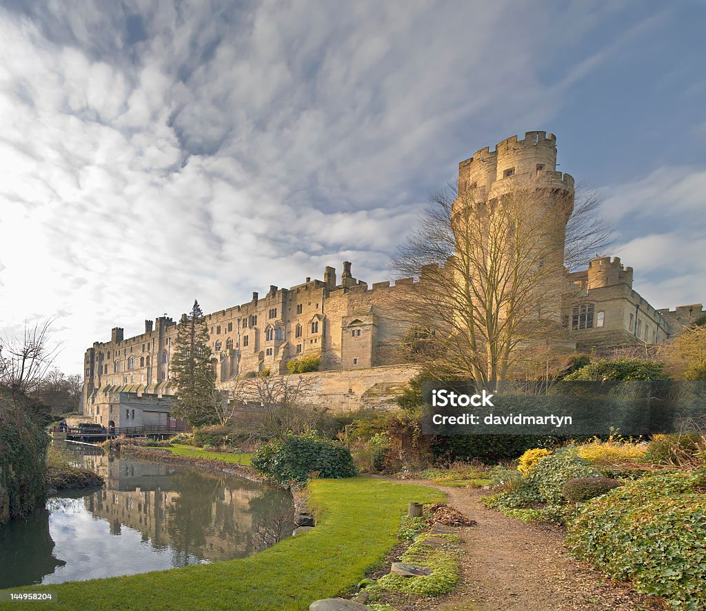 A view to Warwick Castle on a cloudy day A view of warwick castle and the river avon, warwickshire midlands england uk. Warwickshire Stock Photo