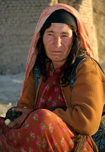 Dowlat Yar, Ghor Province / Afghanistan: Portrait of an old woman near the town of Dowlatyar in Central Afghanistan. She has traditional facial tattoos (the blue ink dots on her face).