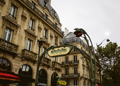 Closeup of Victory street name on the traditional parisian street plate on stoned building - (rue de la victoire in french)