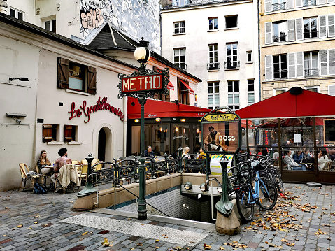 Paris, France - March 17, 2023: People at cafe terrace of iconic bookshop Shakespeare and Company in the Latin Quarter in Paris, France.