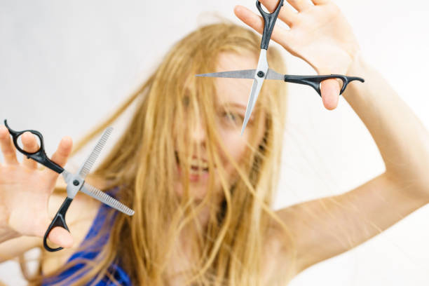 istock Girl with scissors for haircutting 1449583744