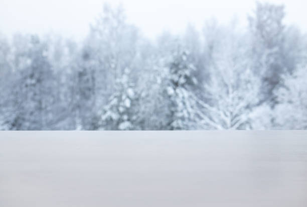 istock Winter products advertising background. Focus on white table with white magical snowy trees on background. Lot of copy space. Not actually manipulation, shot outside. 1449583777