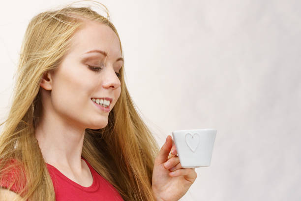istock Blonde girl with coffee cup 1449583785