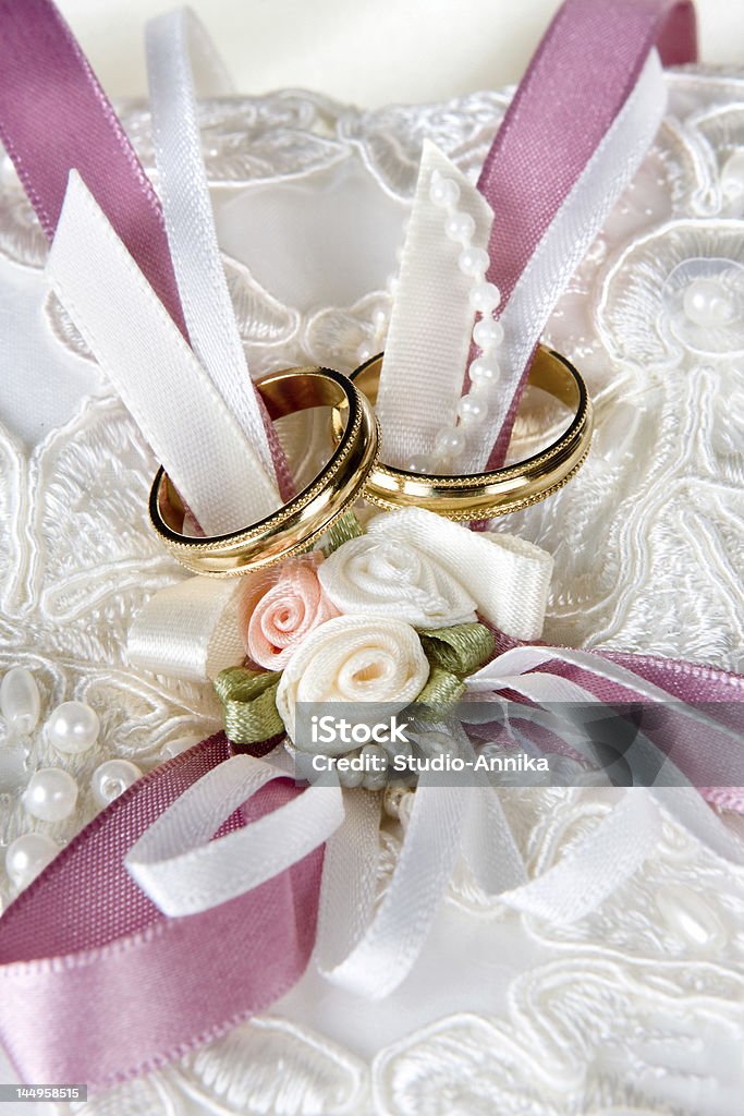 Rings and vows Wedding rings lying on a decorated cushion Bead Stock Photo