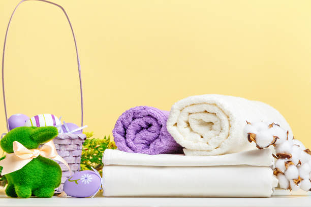 istock Towel rolls white bed linen with easter decor on the table 1449585691