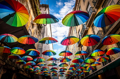 Lisbon, Portugal - October 31, 2022: View to a narrow alley with many umbrellas in old town of Lisbon