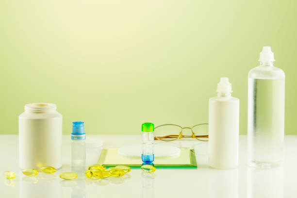 Oftalmology concept with containers with contact lenses, eye drops, clean solutions, vitamins and eyeglasses. Night contact lenses. Advertising contact lenses for vision. Optical store and eye care