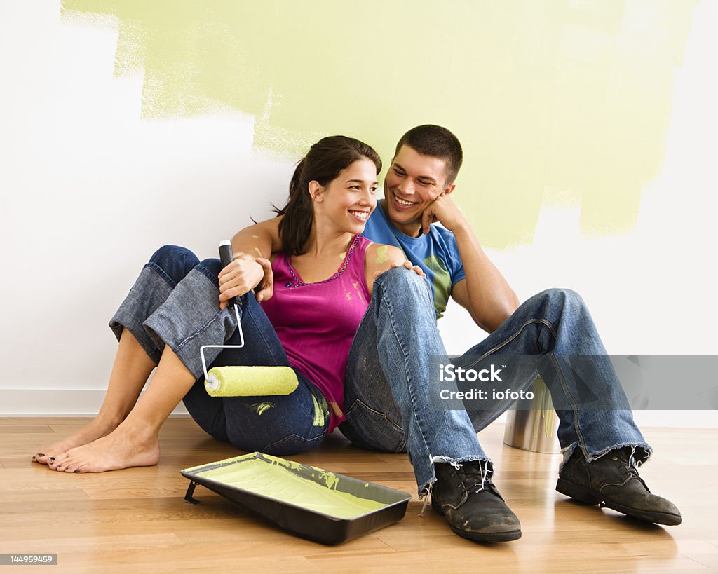 Souriant couple avec peinture de documents. - Photo de Mur libre de droits