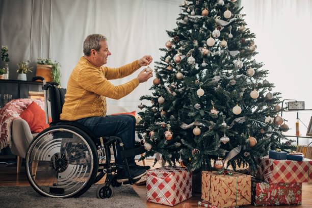 istock A disabled senior decorates the Christmas tree 1449594656