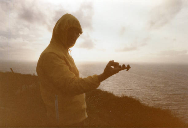 Young man with snails on his finger, photo taken on Cliffs of Moher in 1993