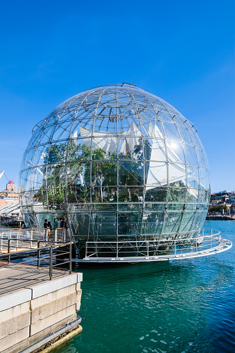 Tourists entering the Biosphere, a glass and steel structure located in the Porto Antico of Genoa, where a portion of tropical rain forest has been reconstructed, with over 150 species of animal and plant organisms.