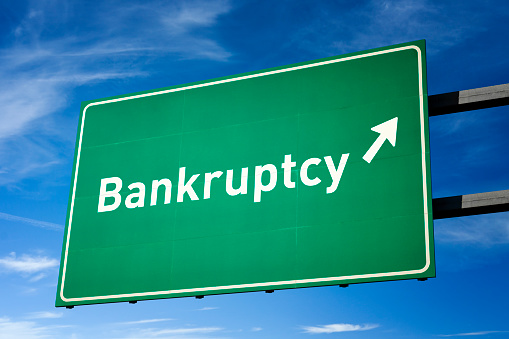 Highway directional sign for Bankruptcy. Isolated with clipping path.